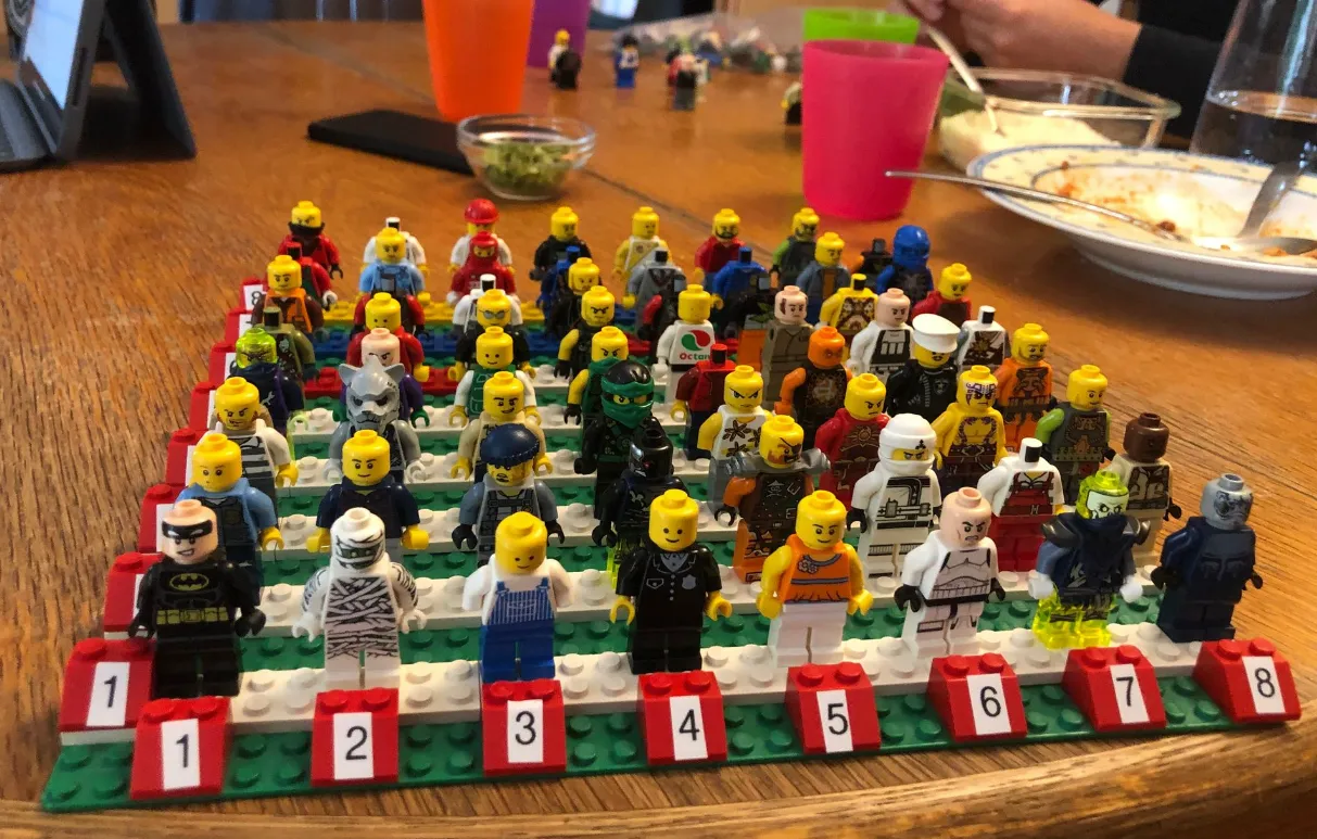Dozens of Minifigures lined up on numbered plates for training photos